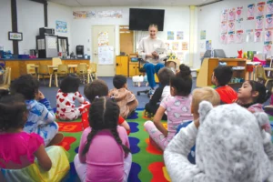 woman reading to children in classroom