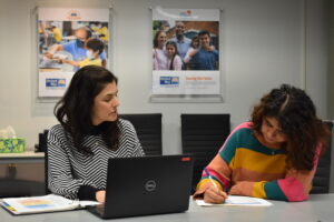 women at computer doing paperwork