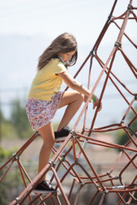 child climbing on play structure